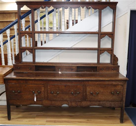 An 18th century oak dresser with open rack W187cm